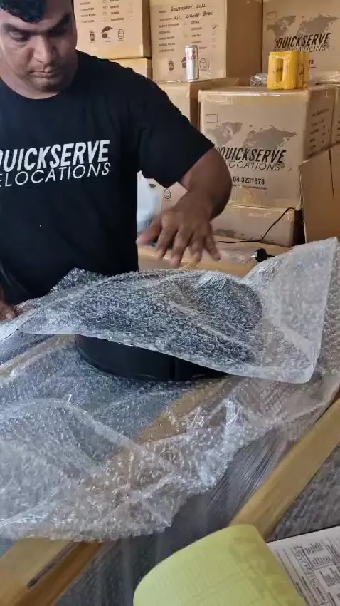 QuickServe crew bubble-wrapping a fragile item