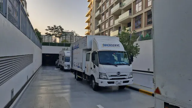 Two QuickServe trucks at a residential ramp